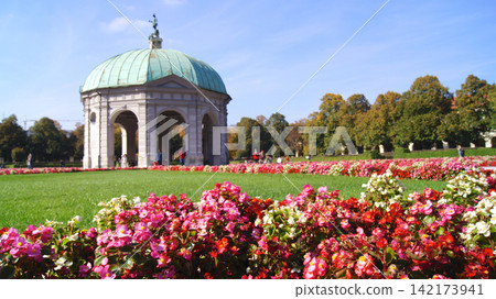 Munich, Germany, October 12 2015: Historic round building with arcades and flowers in park Munich, Germany, October 12 2015: Historic round building with arcades and flowers in park 142173941