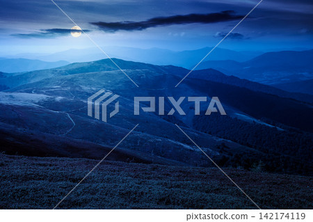 Carpathian mountain landscape in late summer at night. full moon over scenic view of Transcarpathia region from the Great Summit. mysterious alpine blueberry field on Polonyna Play hill Carpathian mountain landscape in late summer at night. full moon over scenic view of Transcarpathia region from the Great Summit. mysterious alpine blueberry field on Polonyna Play hill 142174119