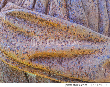 Close up view of a sculpted metal object showing rust and texture in shades of orange, brown, and bluish tones Close up view of a sculpted metal object showing rust and texture in shades of orange, brown, and bluish tones 142174195