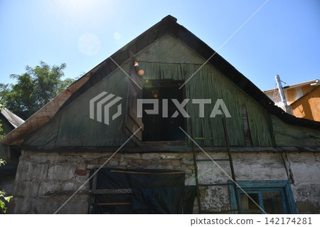 Interior of the attic of house with boxes and old appliances under gable roof Interior of the attic of house with boxes and old appliances under gable roof 142174281