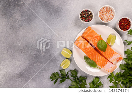 Raw salmon fillets preparing for healthy cooking Raw salmon fillets preparing for healthy cooking 142174374