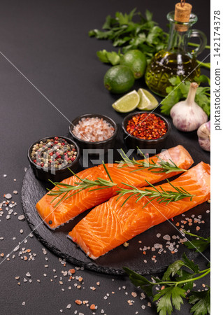 Raw salmon fillets with rosemary, spices, and olive oil Raw salmon fillets with rosemary, spices, and olive oil 142174378
