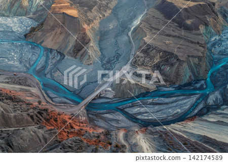 Aerial Canyon Landscape with Turquoise Braided River and Bridge Aerial Canyon Landscape with Turquoise Braided River and Bridge 142174589