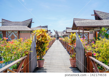 Tropical Water Village with Traditional Wooden Houses and Walkway Tropical Water Village with Traditional Wooden Houses and Walkway 142174638