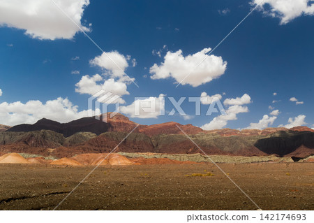 Desert Landscape with Red Mountains and Blue Sky 142174693