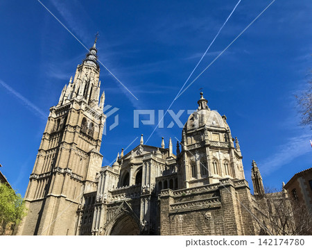 Gothic Cathedral Tower and Dome Under Blue Sky in Toledo Gothic Cathedral Tower and Dome Under Blue Sky in Toledo 142174780