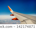Aircraft Wing Against Clear Blue Sky Background Aircraft Wing Against Clear Blue Sky Background 142174871