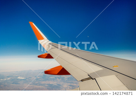 Aircraft Wing Against Clear Blue Sky Background Aircraft Wing Against Clear Blue Sky Background 142174871