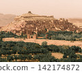 Hilltop fortress above desert oasis Hilltop fortress above desert oasis 142174872