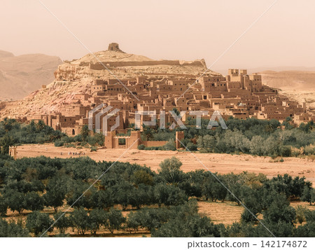 Hilltop fortress above desert oasis Hilltop fortress above desert oasis 142174872