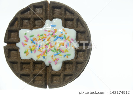 Waffles topped with yogurt and colorful sprinkles - close-up and overhead view Waffles topped with yogurt and colorful sprinkles - close-up and overhead view 142174912