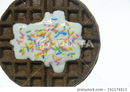 Waffles topped with yogurt and colorful sprinkles - close-up and overhead view Waffles topped with yogurt and colorful sprinkles - close-up and overhead view 142174913
