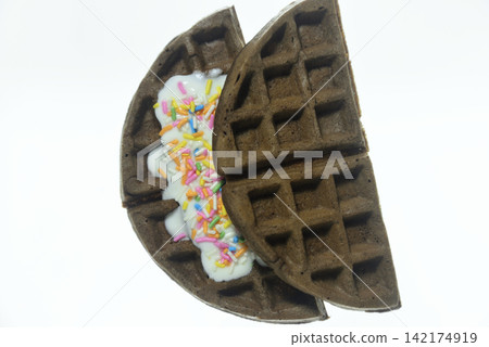 Waffles topped with yogurt and colorful sprinkles - close-up and overhead view Waffles topped with yogurt and colorful sprinkles - close-up and overhead view 142174919