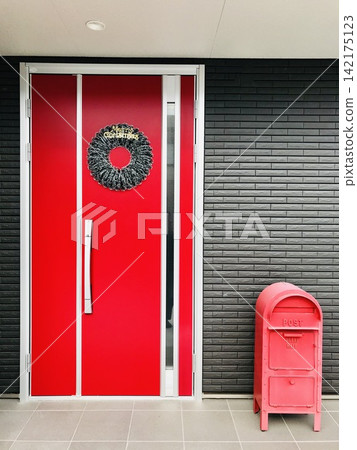 A Christmas wreath adorning the red front door. A Christmas wreath adorning the red front door. 142175123