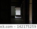 A photograph showing a corridor as a cloister, with shoji screens in the background. 142175259