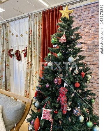 A Christmas tree adorned with colorful ornaments A Christmas tree adorned with colorful ornaments 142175282