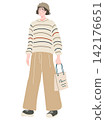 A woman with a shopping bag 142176651