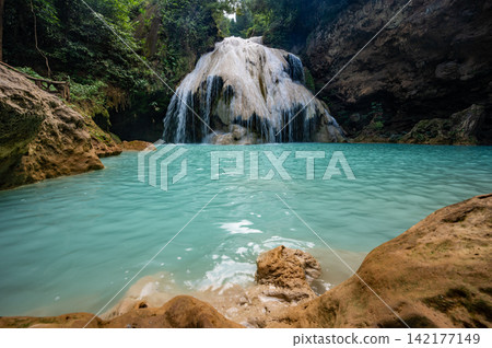 Scenery view of Koh Luang Waterfall in Maeping National Park of Lamphun province, Thailand. It is a limestone waterfall with spectacular beauty. Scenery view of Koh Luang Waterfall in Maeping National Park of Lamphun province, Thailand. It is a limestone waterfall with spectacular beauty. 142177149