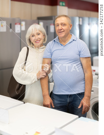 Elderly couple doing shopping inside consumer electronics supermarket Elderly couple doing shopping inside consumer electronics supermarket 142177258