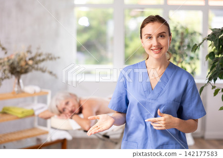 Young woman masseuse posing in spa salon Young woman masseuse posing in spa salon 142177583