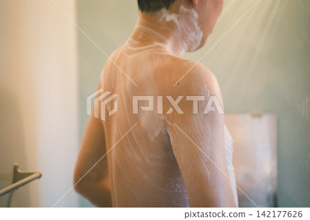 Middle-aged men using men's body wash. Middle-aged men using men's body wash. 142177626