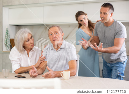 Family quarrel - couple is unhappy with elderly parents, express dissatisfaction Family quarrel - couple is unhappy with elderly parents, express dissatisfaction 142177710