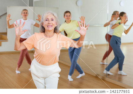 Aged lady learning to dance in studio Aged lady learning to dance in studio 142177931