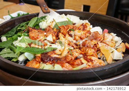 Spicy Korean Chicken Stir Fry Dakgalbi with Vegetables on Iron Pan Spicy Korean Chicken Stir Fry Dakgalbi with Vegetables on Iron Pan 142178912