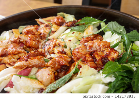 Spicy Korean Chicken Stir Fry Dakgalbi with Vegetables on Iron Pan Spicy Korean Chicken Stir Fry Dakgalbi with Vegetables on Iron Pan 142178933