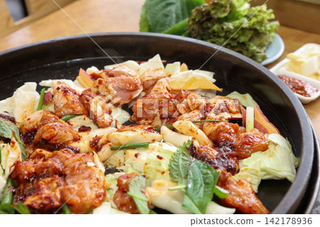Spicy Korean Chicken Stir Fry Dakgalbi with Vegetables on Iron Pan Spicy Korean Chicken Stir Fry Dakgalbi with Vegetables on Iron Pan 142178936