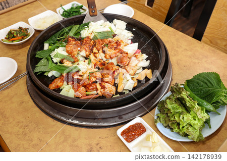 Spicy Korean Chicken Stir Fry Dakgalbi with Vegetables on Iron Pan Spicy Korean Chicken Stir Fry Dakgalbi with Vegetables on Iron Pan 142178939