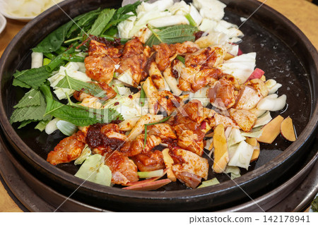 Spicy Korean Chicken Stir Fry Dakgalbi with Vegetables on Iron Pan Spicy Korean Chicken Stir Fry Dakgalbi with Vegetables on Iron Pan 142178941