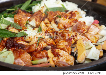 Spicy Korean Chicken Stir Fry Dakgalbi with Vegetables on Iron Pan Spicy Korean Chicken Stir Fry Dakgalbi with Vegetables on Iron Pan 142178943