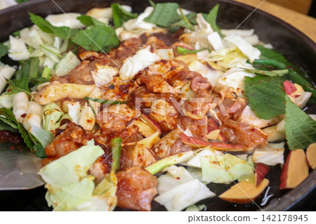 Spicy Korean Chicken Stir Fry Dakgalbi with Vegetables on Iron Pan Spicy Korean Chicken Stir Fry Dakgalbi with Vegetables on Iron Pan 142178945