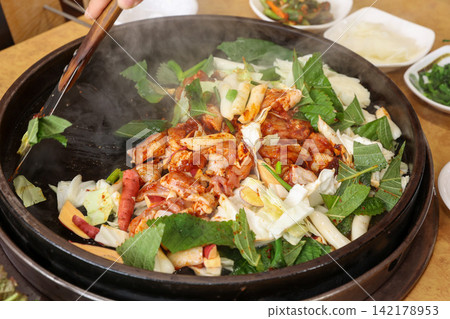 Spicy Korean Chicken Stir Fry Dakgalbi with Vegetables on Iron Pan Spicy Korean Chicken Stir Fry Dakgalbi with Vegetables on Iron Pan 142178953