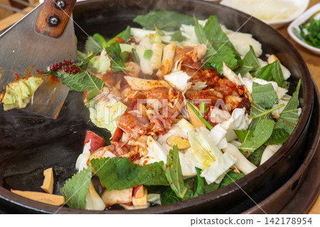 Spicy Korean Chicken Stir Fry Dakgalbi with Vegetables on Iron Pan Spicy Korean Chicken Stir Fry Dakgalbi with Vegetables on Iron Pan 142178954