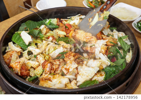 Spicy Korean Chicken Stir Fry Dakgalbi with Vegetables on Iron Pan Spicy Korean Chicken Stir Fry Dakgalbi with Vegetables on Iron Pan 142178956
