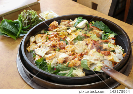 Spicy Korean Chicken Stir Fry Dakgalbi with Vegetables on Iron Pan Spicy Korean Chicken Stir Fry Dakgalbi with Vegetables on Iron Pan 142178964