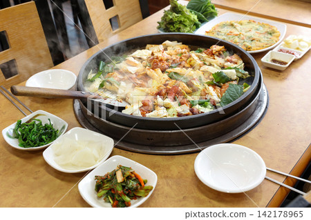 Spicy Korean Chicken Stir Fry Dakgalbi with Vegetables on Iron Pan Spicy Korean Chicken Stir Fry Dakgalbi with Vegetables on Iron Pan 142178965