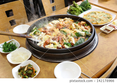 Spicy Korean Chicken Stir Fry Dakgalbi with Vegetables on Iron Pan Spicy Korean Chicken Stir Fry Dakgalbi with Vegetables on Iron Pan 142178966