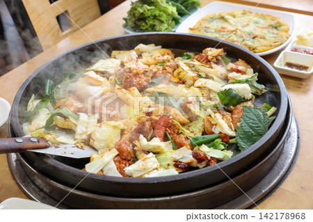 Spicy Korean Chicken Stir Fry Dakgalbi with Vegetables on Iron Pan 142178968