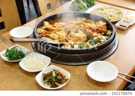 Spicy Korean Chicken Stir Fry Dakgalbi with Vegetables on Iron Pan Spicy Korean Chicken Stir Fry Dakgalbi with Vegetables on Iron Pan 142178979