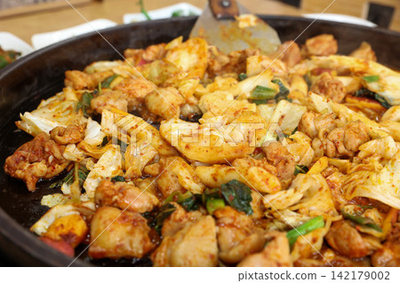 Spicy Korean Chicken Stir Fry Dakgalbi with Vegetables on Iron Pan Spicy Korean Chicken Stir Fry Dakgalbi with Vegetables on Iron Pan 142179002