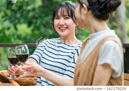 Young women enjoying meals on the terrace, barbecues, home parties, and glamping with friends. Young women enjoying meals on the terrace, barbecues, home parties, and glamping with friends. 142179224