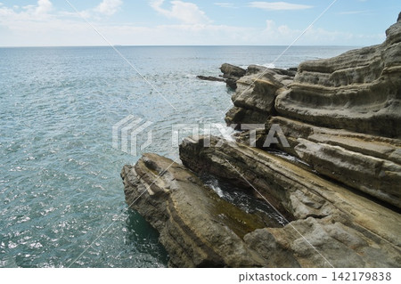 Okinoshima Island in Chiba Prefecture: A landscape of rocky reefs jutting out into the sea and the blue ocean. Okinoshima Island in Chiba Prefecture: A landscape of rocky reefs jutting out into the sea and the blue ocean. 142179838