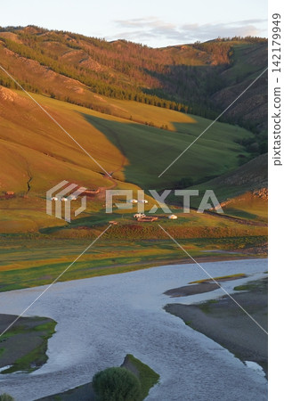 The Orkhon River flowing around Karakorum, Mongolia, and yurts in the grasslands. The Orkhon River flowing around Karakorum, Mongolia, and yurts in the grasslands. 142179949