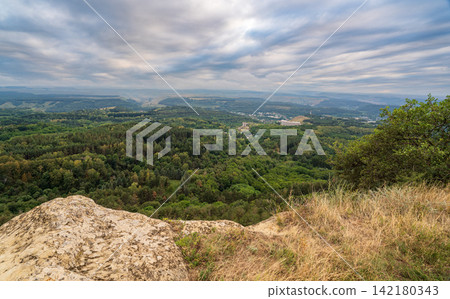 View of the mountains and Kislovodsk from the observation decks of the Kislovodsk Park. Evening sunset over the mountains of Kislovodsk. View of the mountains and Kislovodsk from the observation decks of the Kislovodsk Park. Evening sunset over the mountains of Kislovodsk. 142180343