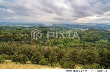 Layers of green mountains and hills in the haze during sunset. Panoramic View of Green hills and Meadow. Layers of green mountains and hills in the haze during sunset. Panoramic View of Green hills and Meadow. 142180521