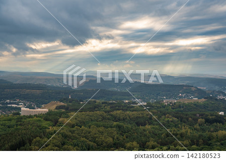 View of the mountains and Kislovodsk from the observation decks of the Kislovodsk Park. Evening sunset over the mountains of Kislovodsk. View of the mountains and Kislovodsk from the observation decks of the Kislovodsk Park. Evening sunset over the mountains of Kislovodsk. 142180523