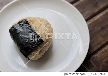 Triangular rice balls made with brown rice from Akita Komachi rice. Triangular rice balls made with brown rice from Akita Komachi rice. 142181961